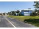 Bright blue two-story home featuring three-car garage, mature landscaping and metal roof at 1787 Earhart Ct, Port Orange, FL 32128