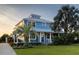 Stunning two-story home with metal roof, lush landscaping, and a charming covered porch at 1787 Earhart Ct, Port Orange, FL 32128