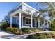 Beautiful two-story home featuring a spacious covered porch with stylish columns and lush landscaping at 1787 Earhart Ct, Port Orange, FL 32128