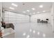 Spacious garage with large sliding door and ample room for multiple vehicles or equipment and grey sealed floors at 1787 Earhart Ct, Port Orange, FL 32128