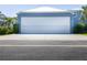 Exterior view of the garage with white garage door at 1787 Earhart Ct, Port Orange, FL 32128