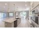 Open-concept kitchen with stainless steel appliances and a view of the dining and living area at 1787 Earhart Ct, Port Orange, FL 32128