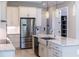 Kitchen with stainless steel appliances, white cabinets, and a kitchen island with bar seating at 1787 Earhart Ct, Port Orange, FL 32128