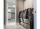 Laundry room with gray washer and dryer in view of the walk-in closet at 1787 Earhart Ct, Port Orange, FL 32128