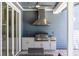 Patio with outdoor kitchen including grill, hood, sink, and cabinets at 1787 Earhart Ct, Port Orange, FL 32128