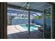 Screened-in patio with a swimming pool and integrated jacuzzi at 1787 Earhart Ct, Port Orange, FL 32128