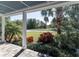 Covered porch with elegant white columns and lush landscaping with mature palm trees in view at 1787 Earhart Ct, Port Orange, FL 32128