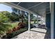 Covered front porch with brick flooring and white columns, overlooking a beautifully landscaped yard at 1787 Earhart Ct, Port Orange, FL 32128