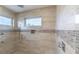Modern shower features decorative tile, bench seat, and dual shower heads at 1787 Earhart Ct, Port Orange, FL 32128