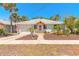 Charming home featuring a tidy yard, quaint porch, and an attached one-car garage at 208 Crawford Rd, New Smyrna Beach, FL 32169