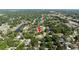 Aerial view of the surrounding neighborhood with established trees and bodies of water nearby at 2204 Kumquat Dr, Edgewater, FL 32141