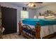 Cozy bedroom featuring a decorative iron bed frame, a ceiling fan, and a window with natural light at 2204 Kumquat Dr, Edgewater, FL 32141