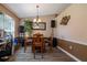 Cozy dining area with a wooden table, chandelier, and neutral wall colors at 2204 Kumquat Dr, Edgewater, FL 32141