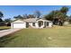 Charming one-story home with an attached two-car garage and freshly cut lawn at 2204 Kumquat Dr, Edgewater, FL 32141