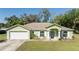 Charming single-story home with a well-manicured lawn and attached two-car garage at 2204 Kumquat Dr, Edgewater, FL 32141