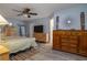 Serene main bedroom with wood-look flooring, dresser, and an ensuite bathroom at 2204 Kumquat Dr, Edgewater, FL 32141
