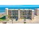Condo building with ocean view, balconies, palm trees, and parking in front at 2222 Ocean Shore Blvd # 201B, Ormond Beach, FL 32176