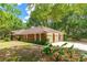 Traditional brick home with a three-car garage and a well-maintained lawn at 32030 Dewberry Ln, Sorrento, FL 32776