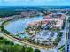 Aerial view of a lakeside apartment complex, parking lot, pool and surrounding neighborhood at 3455 Pegaso Ave, New Smyrna Beach, FL 32168