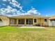 Spacious screened-in patio overlooking a well-maintained backyard with lush green grass at 3455 Pegaso Ave, New Smyrna Beach, FL 32168