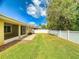 Fully fenced backyard with lawn, lush trees, and mature landscaping at 3455 Pegaso Ave, New Smyrna Beach, FL 32168