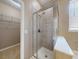 Bathroom features a glass-enclosed shower with tile surround and a walk in closet with built in shelves at 3455 Pegaso Ave, New Smyrna Beach, FL 32168