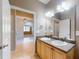 Well-lit bathroom features double sinks, tile floors, and neutral wall paint at 3455 Pegaso Ave, New Smyrna Beach, FL 32168