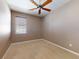 Bedroom features a window with blinds, carpet flooring and ceiling fan at 3455 Pegaso Ave, New Smyrna Beach, FL 32168