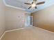 Spacious bedroom features neutral walls, plush carpeting, crown molding, and a ceiling fan at 3455 Pegaso Ave, New Smyrna Beach, FL 32168