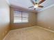 Bedroom with carpet, a window providing natural light, and a ceiling fan at 3455 Pegaso Ave, New Smyrna Beach, FL 32168