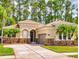 Inviting single-Gathering home with a beige exterior, tile roof, attached garage, and lush green lawn at 3455 Pegaso Ave, New Smyrna Beach, FL 32168