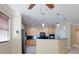 Kitchen with wood cabinets, black appliances, pendant lights, and tiled floors at 3455 Pegaso Ave, New Smyrna Beach, FL 32168