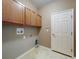 Functional laundry room features upper cabinets, washer hookup, and dryer hookup at 3455 Pegaso Ave, New Smyrna Beach, FL 32168