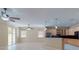 Bright living room featuring an open floor plan with access to the kitchen and sliding glass doors at 3455 Pegaso Ave, New Smyrna Beach, FL 32168