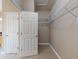 Walk-in closet with carpeted floor is conveniently accessible from inside the house at 3455 Pegaso Ave, New Smyrna Beach, FL 32168
