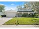 Charming two-story home with a well-maintained lawn, stone accents, and a light blue front door at 3644 Dame St, Port Orange, FL 32129