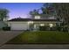 Charming two-story home with stone accents, well-manicured lawn, and attached two-car garage at 3644 Dame St, Port Orange, FL 32129
