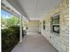 Covered front porch with stone siding, offering a shaded entrance to the home at 3644 Dame St, Port Orange, FL 32129