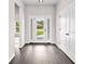 Bright foyer featuring hardwood floors, white trim and a view to the outside at 377 Palm Dr, New Smyrna Beach, FL 32168