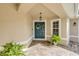 Inviting front entry featuring a teal door, decorative wreath, and brick paver walkway at 4177 Mayfair Ln, Port Orange, FL 32129