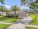 Stunning single-story home with a side entry garage, lush landscaping, and a brick paver driveway at 4177 Mayfair Ln, Port Orange, FL 32129