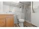Bathroom featuring a shower, toilet, vanity, and in-unit washer/dryer at 5201 S Atlantic Ave # 708A, New Smyrna Beach, FL 32169