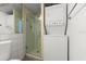 Bathroom featuring a walk-in shower and in-unit washer/dryer at 5201 S Atlantic Ave # 708A, New Smyrna Beach, FL 32169