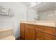 Bathroom featuring a large mirror, vanity with wood cabinets, and a toilet at 5201 S Atlantic Ave # 708A, New Smyrna Beach, FL 32169