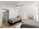 Bedroom featuring twin beds, neutral decor, and wood-look floors at 5201 S Atlantic Ave # 708A, New Smyrna Beach, FL 32169