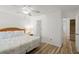 This bright bedroom offers a comfortable bed, wood floors, and ensuite bathroom at 5201 S Atlantic Ave # 708A, New Smyrna Beach, FL 32169
