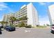 Condo complex featuring private balconies, palm trees, and convenient parking near the beach at 5201 S Atlantic Ave # 708A, New Smyrna Beach, FL 32169