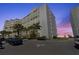 Attractive condo building featuring private balconies, lush landscaping, and convenient parking at 5201 S Atlantic Ave # 708A, New Smyrna Beach, FL 32169