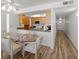 Bright kitchen features wood cabinets, granite countertops, and modern appliances with a dining area at 5201 S Atlantic Ave # 708A, New Smyrna Beach, FL 32169