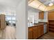 Kitchen with wood cabinets, tile backsplash, stone countertops and ocean view at 5201 S Atlantic Ave # 708A, New Smyrna Beach, FL 32169